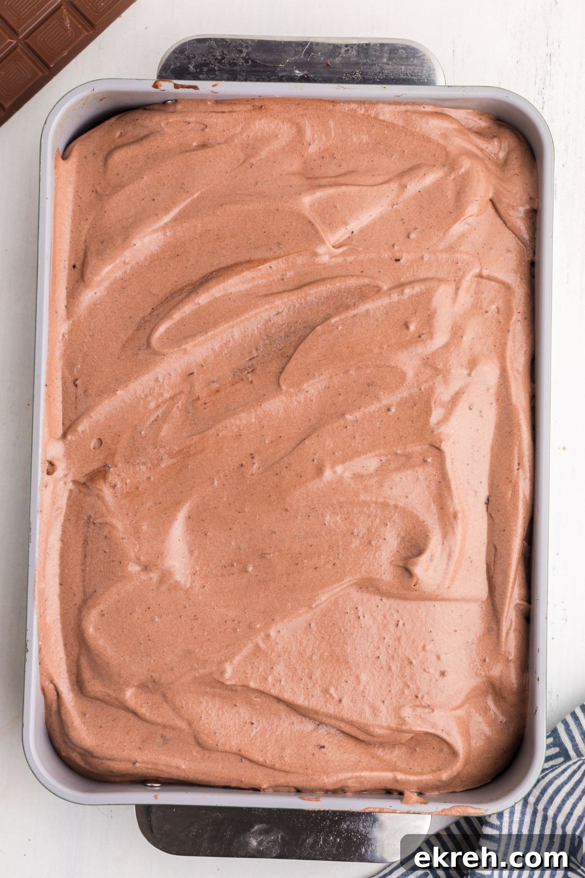 Chocolate cake frosted with chocolate whipped cream topping. 