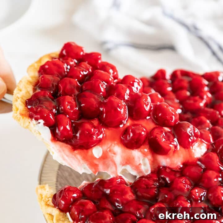 How to Make Apple Pie Filling from Scratch 10 A piece of cherry cheese pie being pulled up from the rest of the pie.