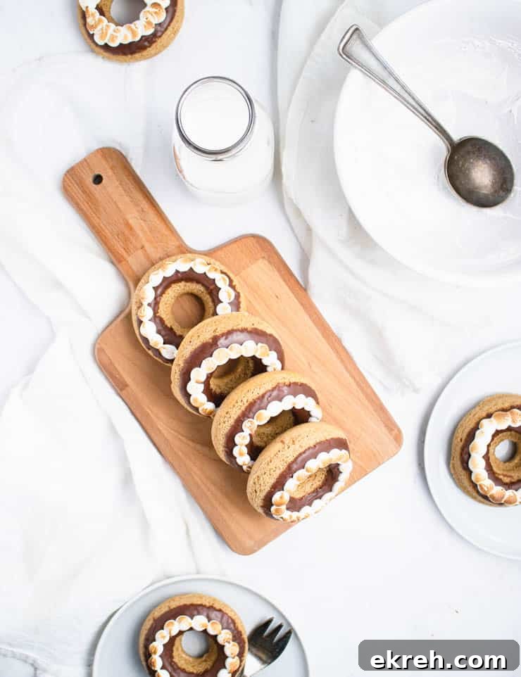 S'mores Donuts Recipe: Chocolate, Marshmallow and Graham 5 doughnuts on a cutting board