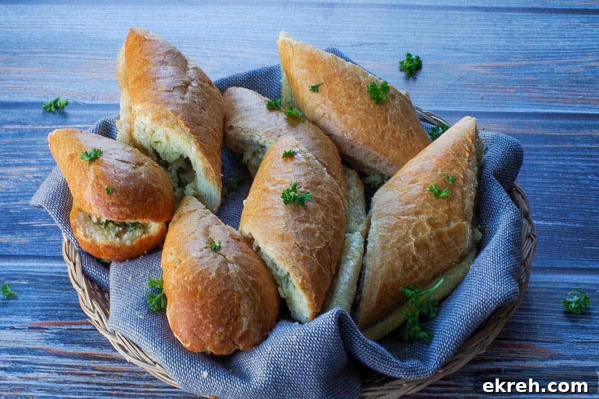 sliced baguette garlic bread in a small basket with a grey liner