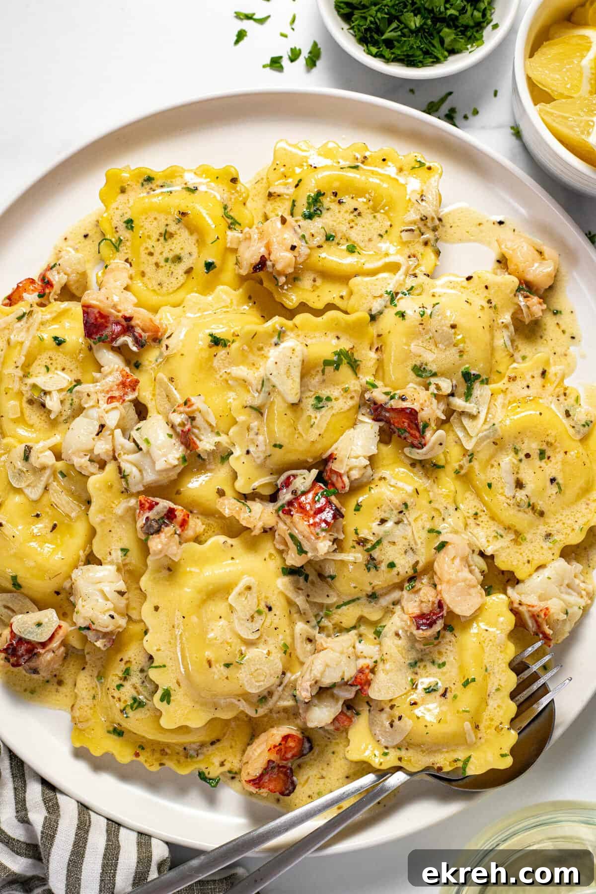 White plate filled with cheese ravioli and a creamy lobster ravioli sauce