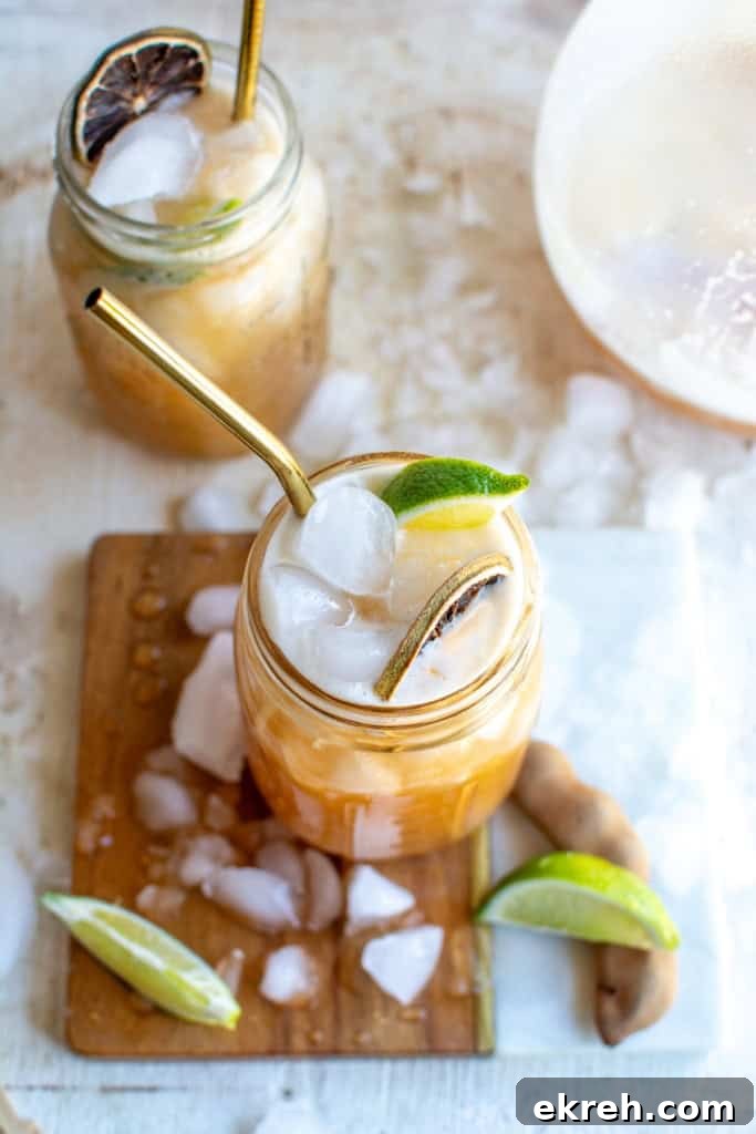 Tamarind Agua Fresca Recipe: Agua de Tamarindo 2 Two glasses of tamarind agua fresca surrounded by ice.