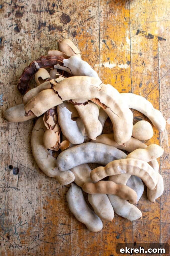 Tamarind Agua Fresca Recipe: Agua de Tamarindo 3 A pile of tamarind on a wood table.