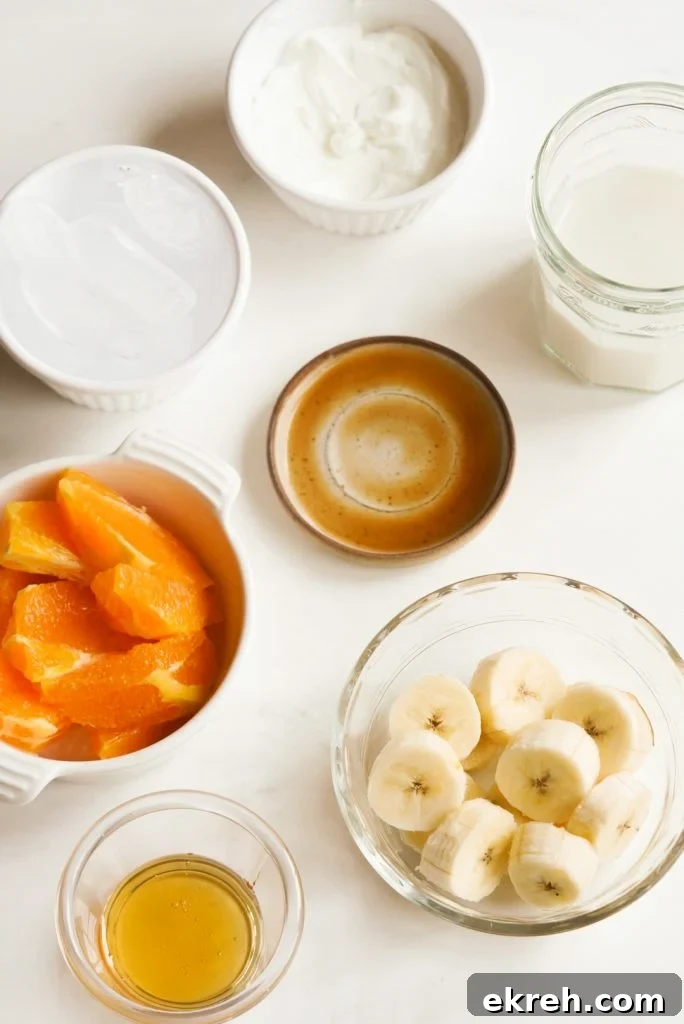 tropical inspired smoothie ingredients measured out on a white table