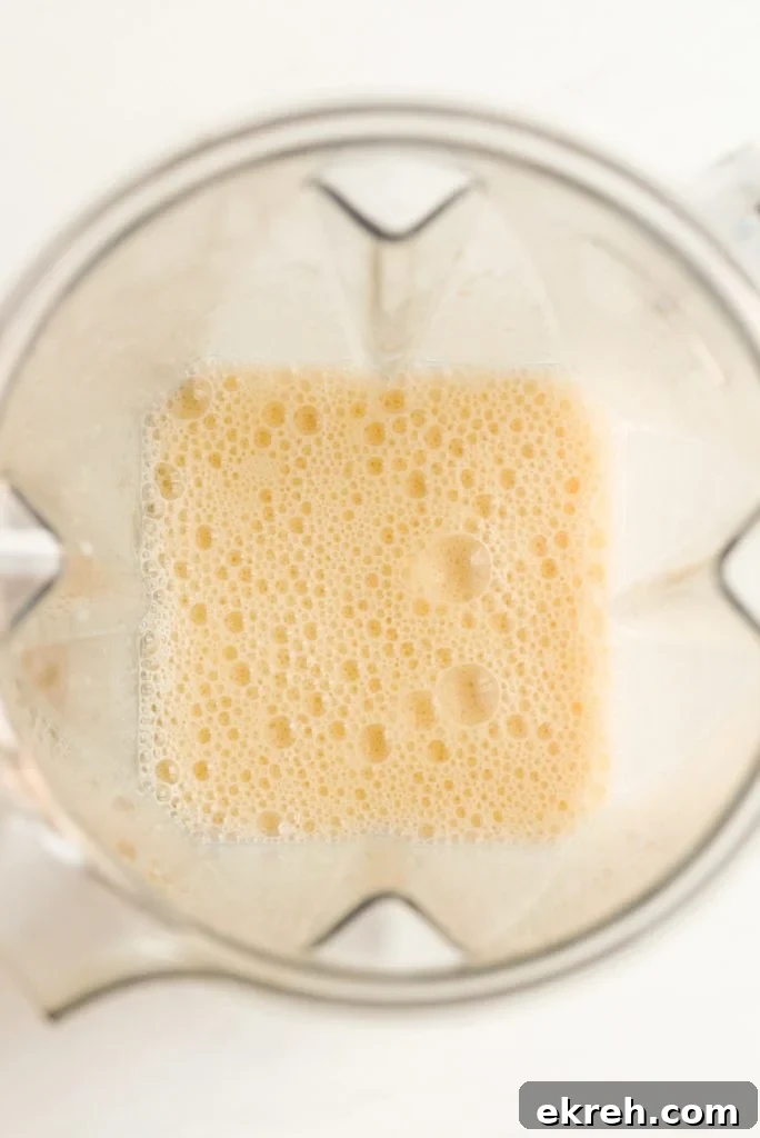 blended orange fruit smoothie in a blender