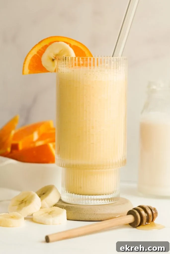 fresh orange smoothie in a drinking glass