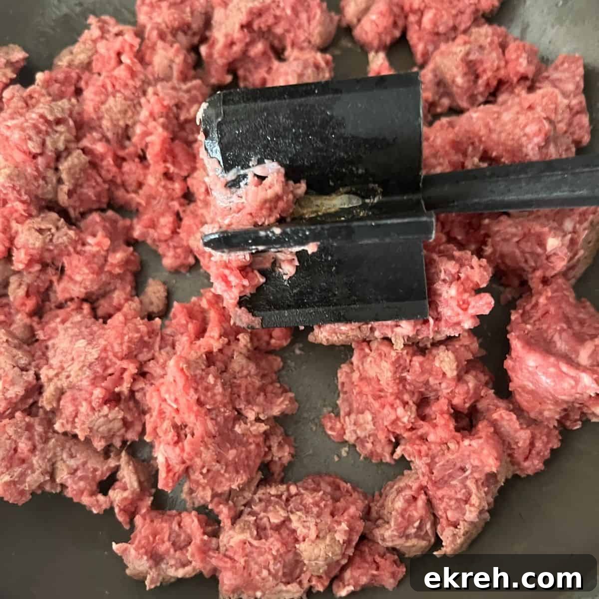 Ground beef broke up in a skillet.