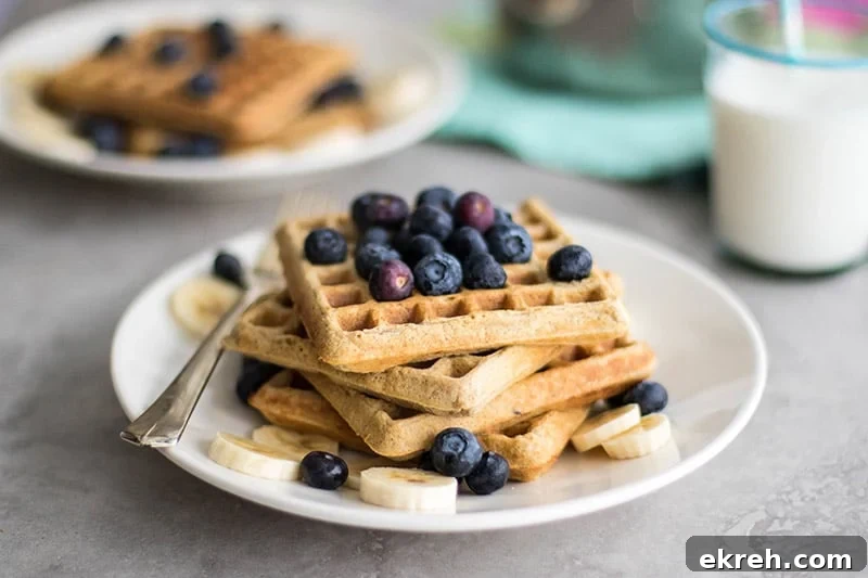 Gluten free waffles topped with a low sugar blueberry syrup.