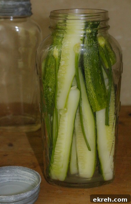 Pack in the cucumbers, then add your hot brining solution