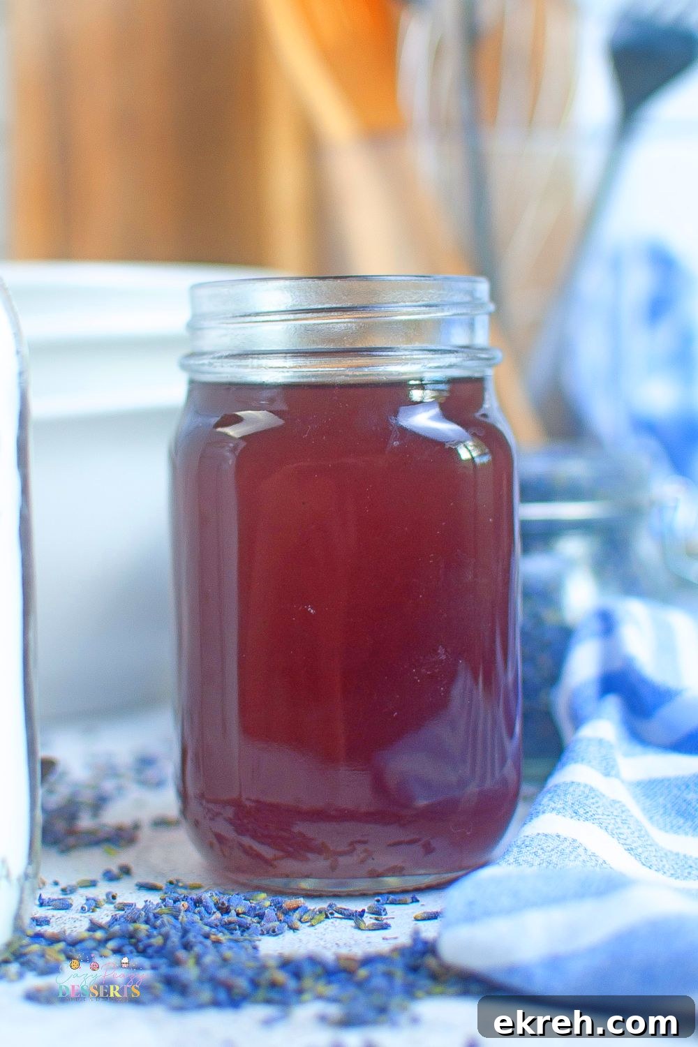 Homemade Lavender Syrup Recipe for Cocktails and Desserts 4 Close up image of a glass jar filled with lavender syrup