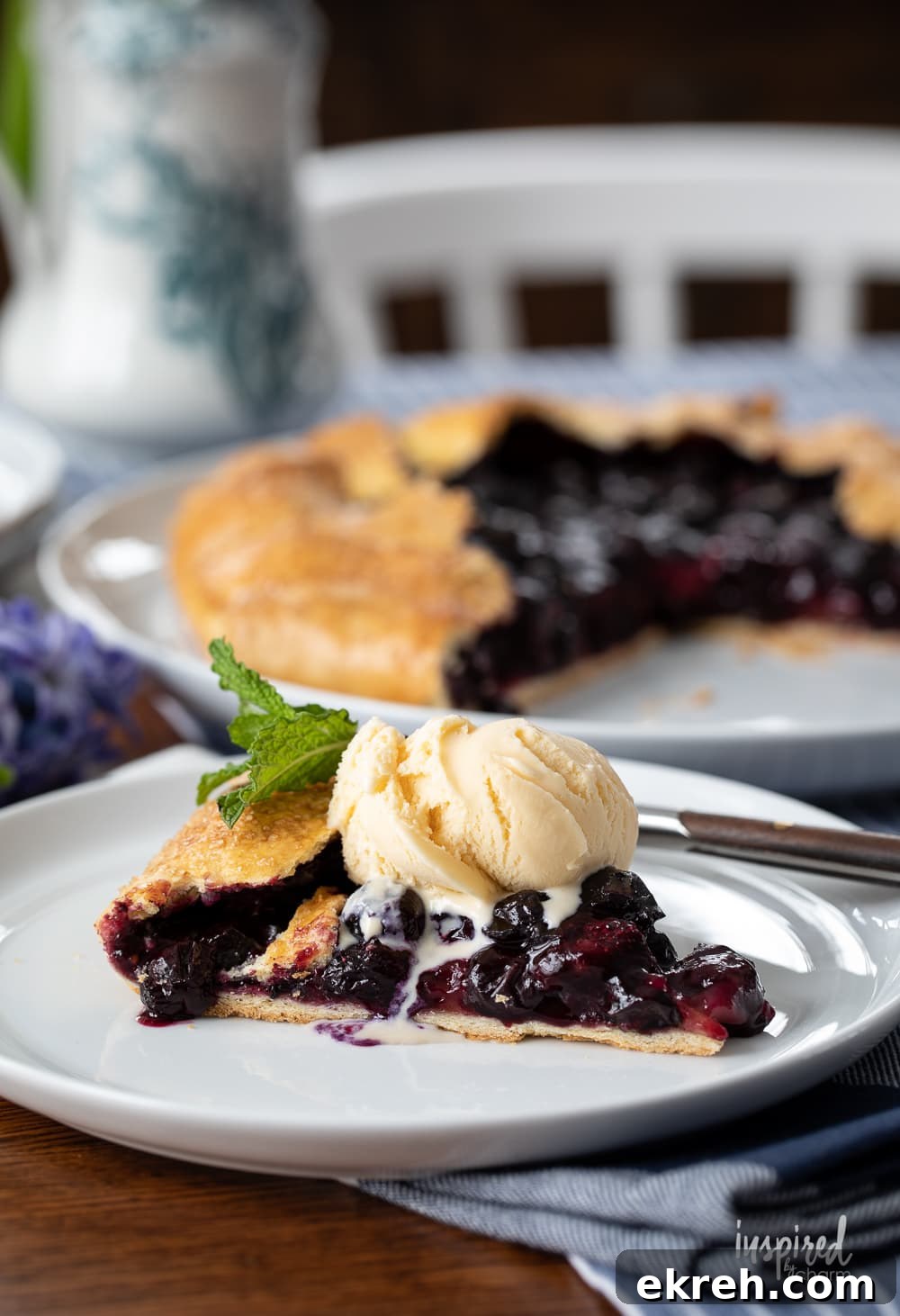 Blueberry Galette Recipe with Rustic Flaky Crust 2 slice of blueberry galette with ice cream on a plate.