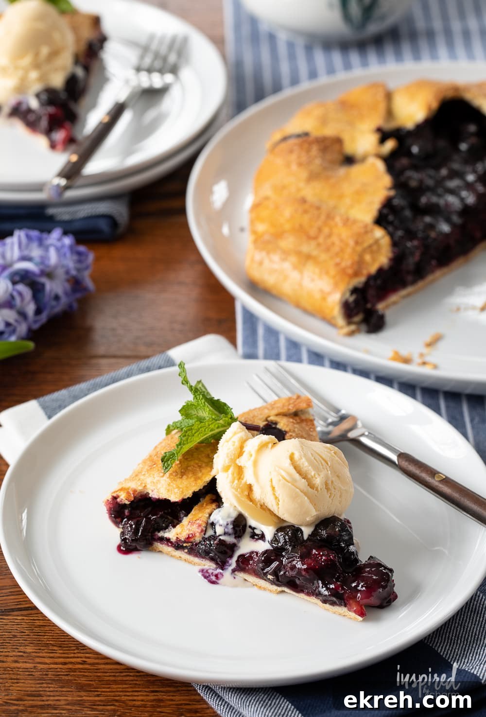 Blueberry Galette Recipe with Rustic Flaky Crust 4 slice of blueberry galette with ice cream on a plate.