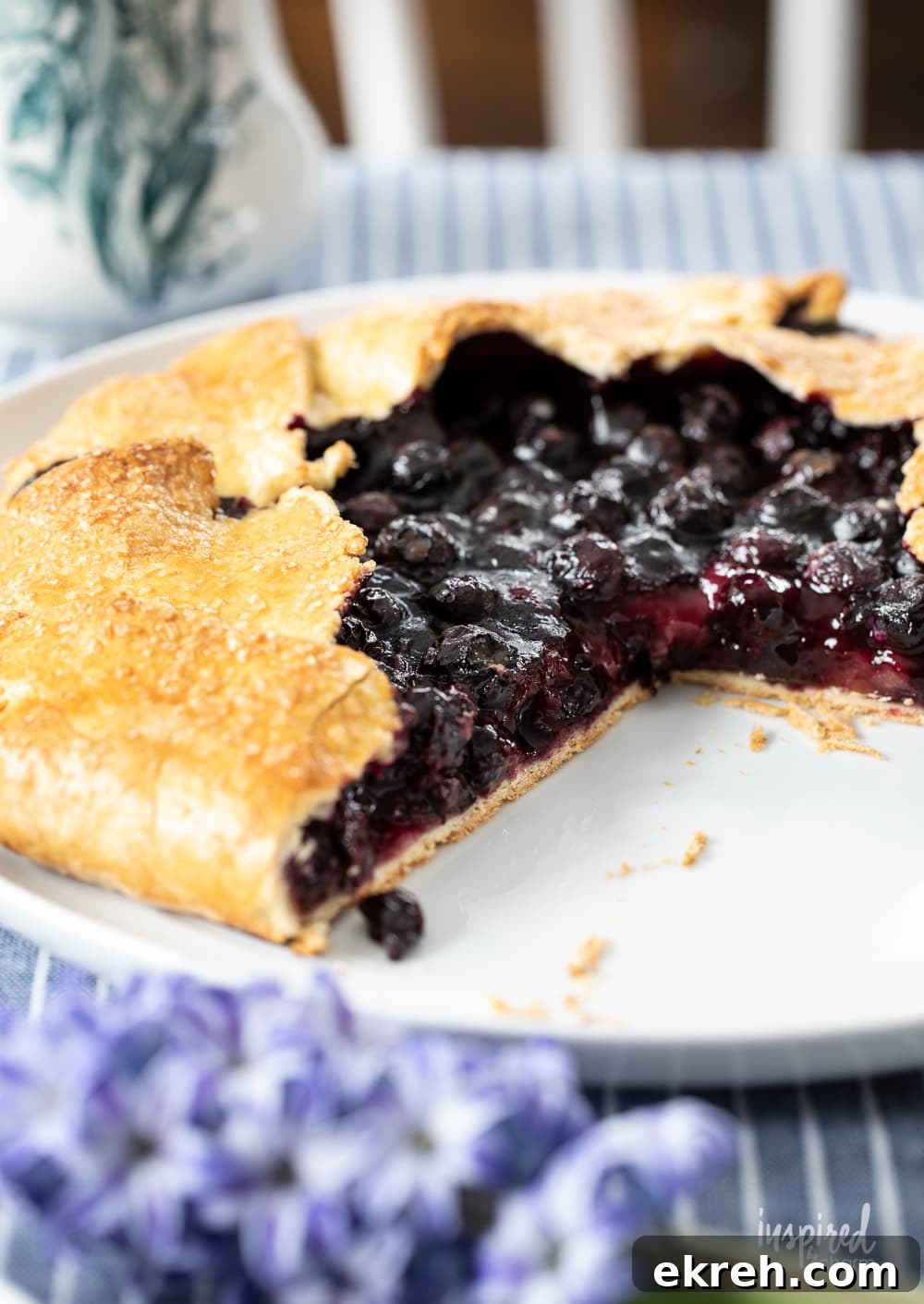Blueberry Galette Recipe with Rustic Flaky Crust 5 whole blueberry galette with a slice missing.