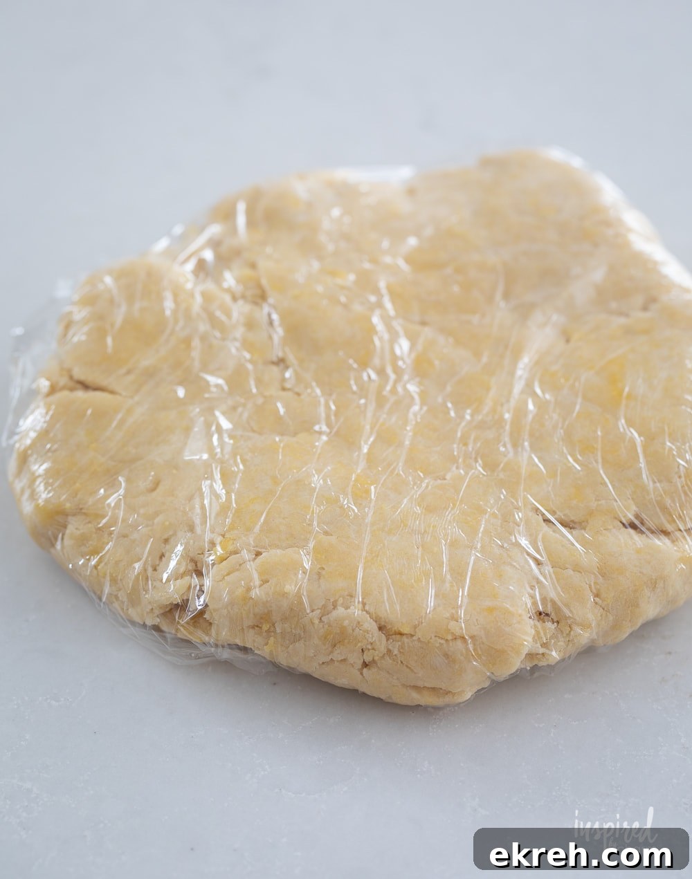 Blueberry Galette Recipe with Rustic Flaky Crust 7 pie dough wrapped in plastic wrap.