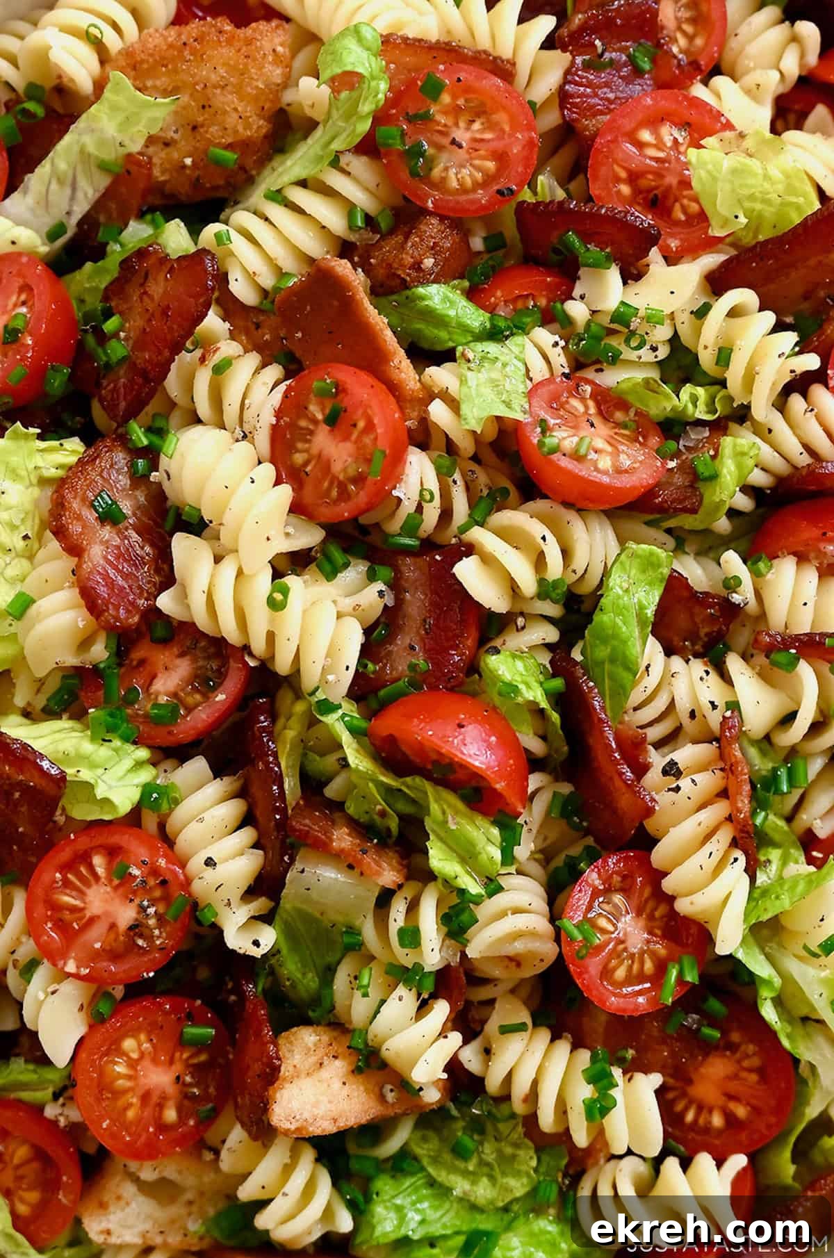 BLT pasta salad with a light red wine dressing and chopped fresh chives.