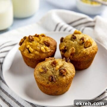 three baked muffins on white plate