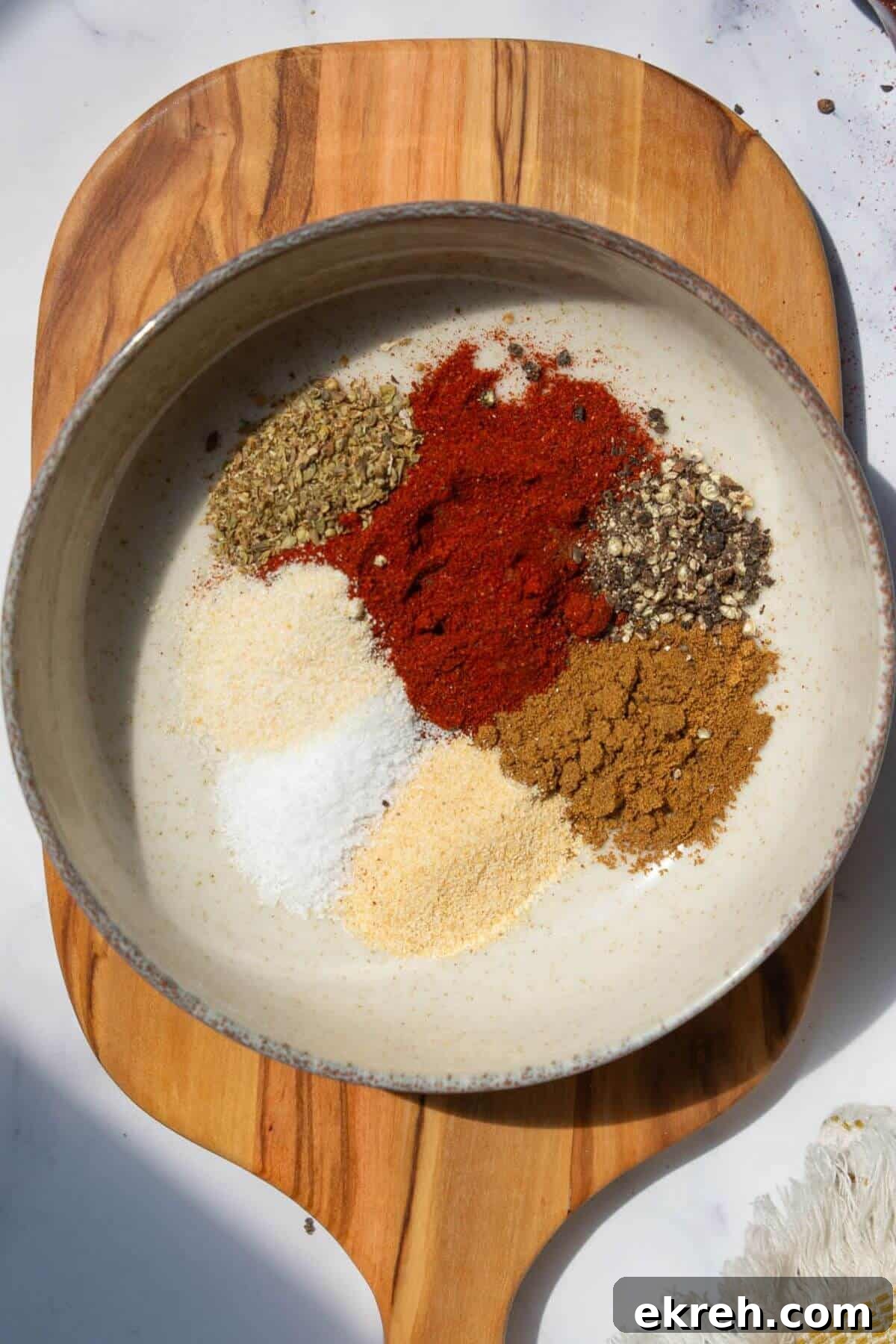 Homemade ground turkey seasoning in a bowl made with simple spices like chili powder, cumin, garlic, paprika, salt, pepper, and onion.
