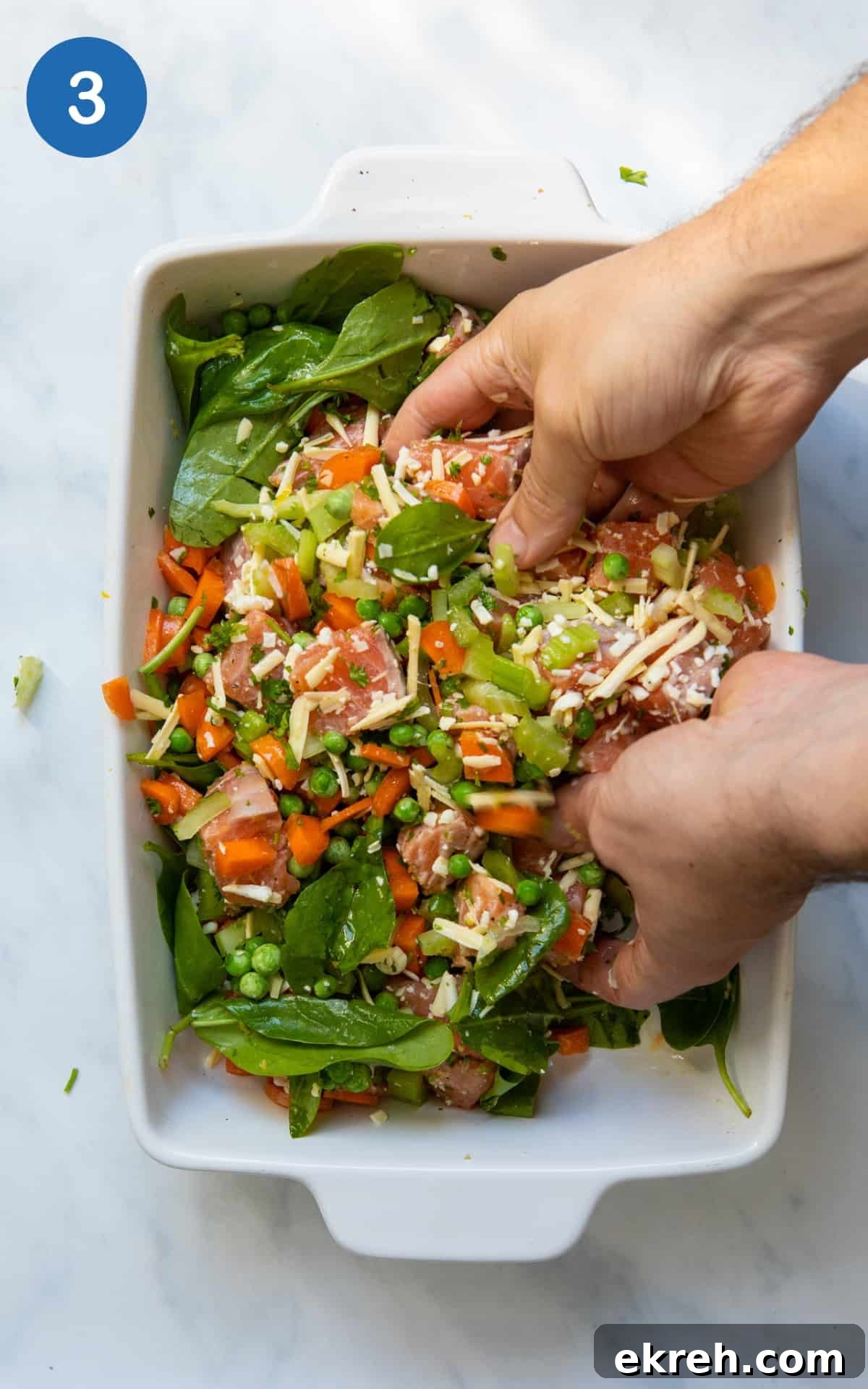Hands mixing ingredients for Salmon Pie in a baking dish.