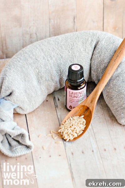 DIY Microwavable Rice Heating Pad - No Sewing Needed 3 bottle of lavender oil and spoon of rice next to homemade heating pad