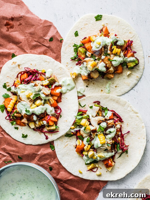 Fish tacos topped with mango salsa and jalapeño cream sauce.
