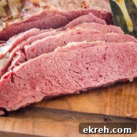 Sliced corned beef on a wooden cutting board.