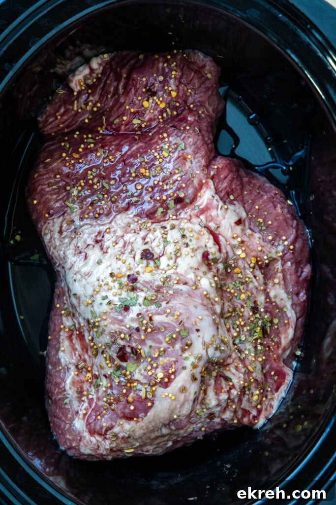 Corned beef in slow cooker Corned beef brisket inside the slow cooker.