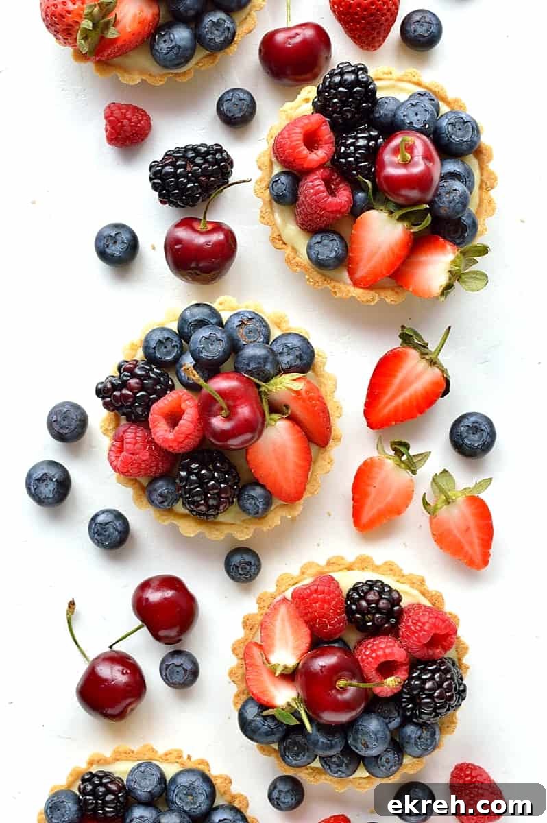 Coconut and berry fruit tarts - crisp coconut pastry with coconut pastry cream and fresh berries.