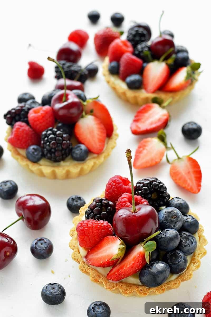 Coconut and berry fruit tarts - crisp coconut pastry with coconut pastry cream and fresh berries.