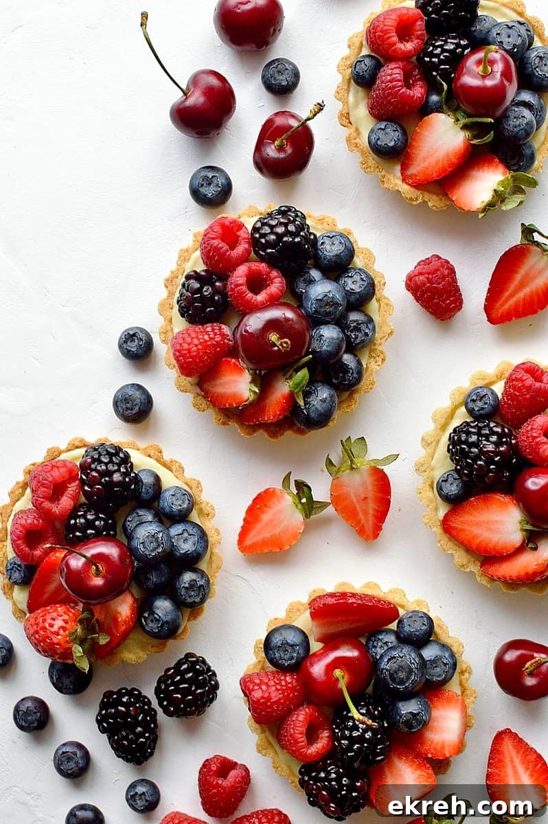 Coconut and berry fruit tarts - crisp coconut pastry with coconut pastry cream and fresh berries.