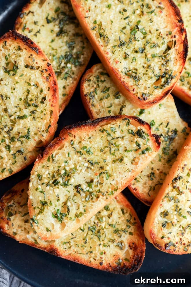 Crispy Sourdough Garlic Toast with Herb Butter 2 easy fresh herb bread slices on a plate with butter