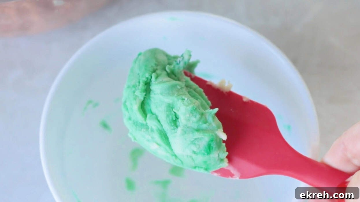 Green shortbread dough on rubber spatula.