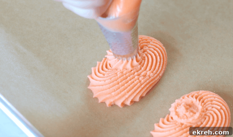 frosting bag piping dough into pumpkin shapes