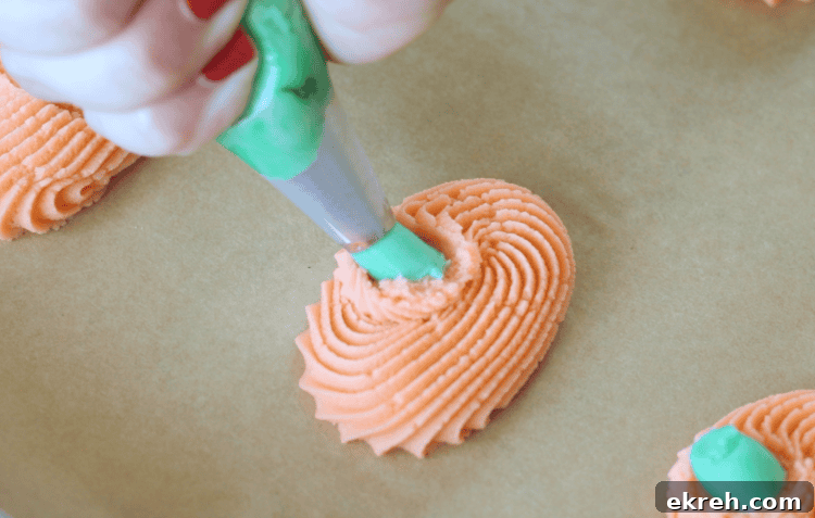 frosting bag piping green stem on cookies