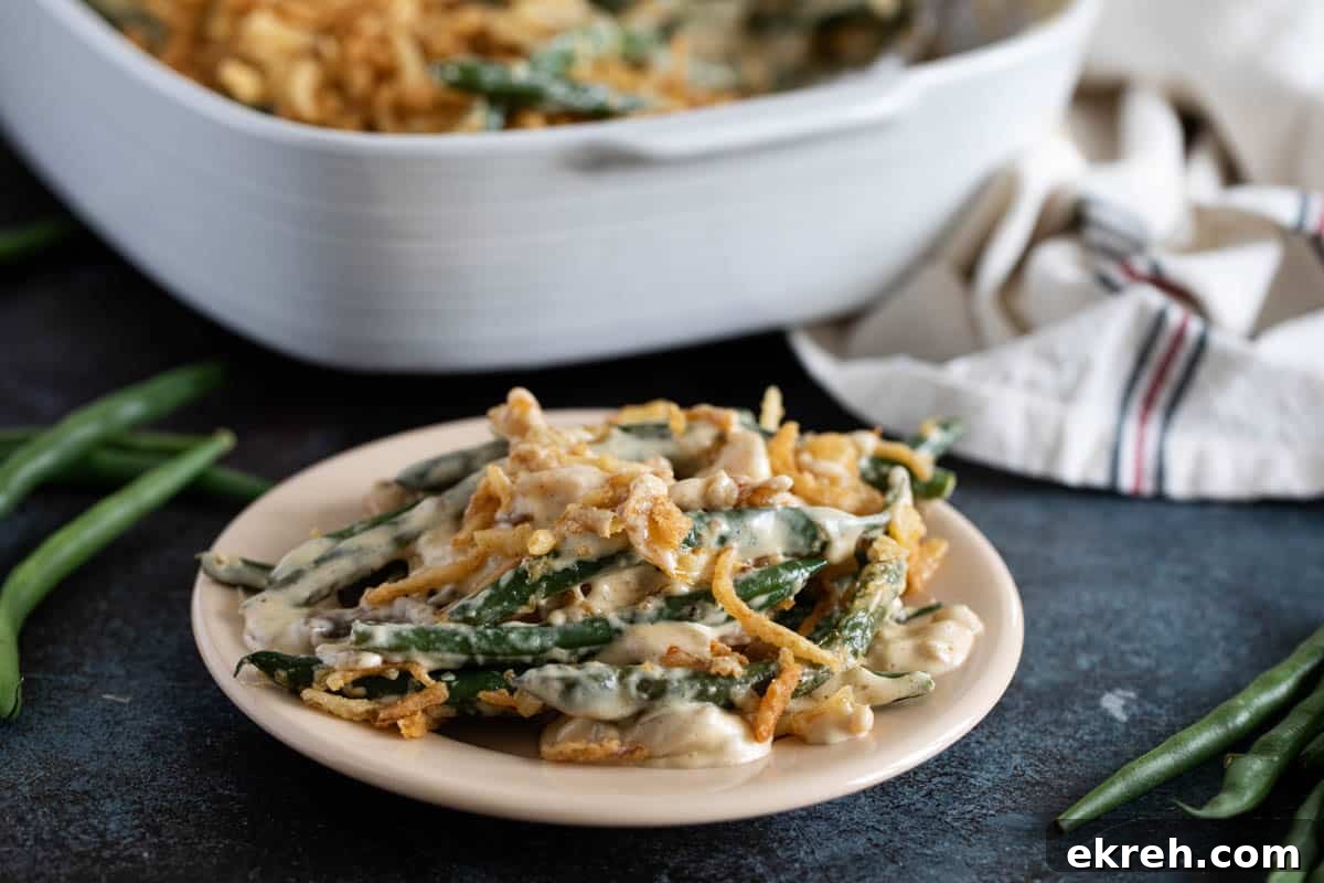 Plate with homemade green bean casserole topped with crispy onion strips.