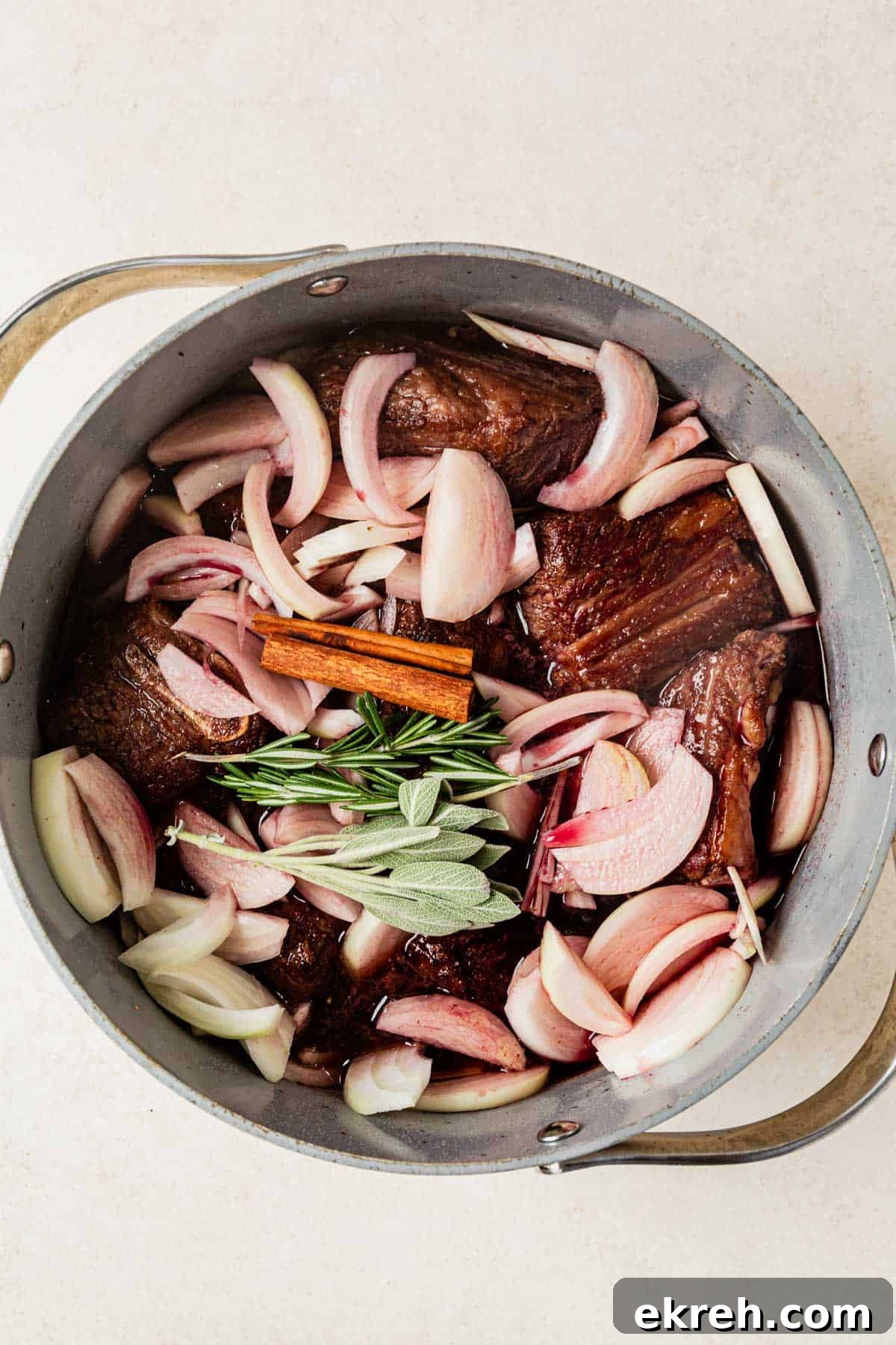 short ribs, pomegranate juice, onions, red wine, and herbs in a dutch oven.