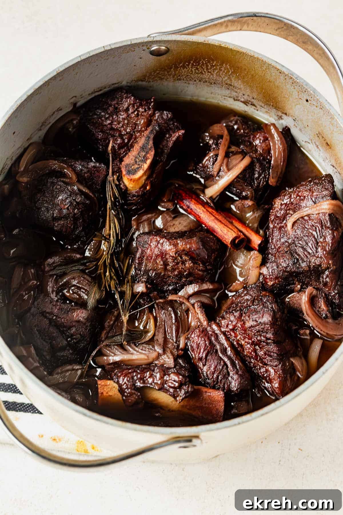 pomegranate braised short ribs cooked in a dutch oven.