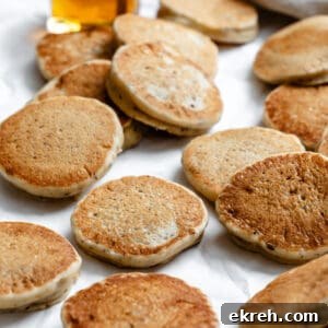several completed Easy Vegan Pancakes [Regular or Mini] on a white surface