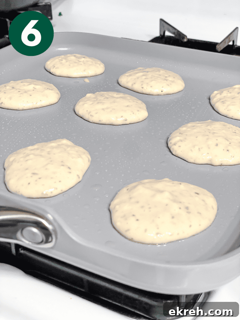 Fluffy Vegan Pancakes: Regular and Mini Recipes 8 process shot showing mini pancakes cooking on a pan