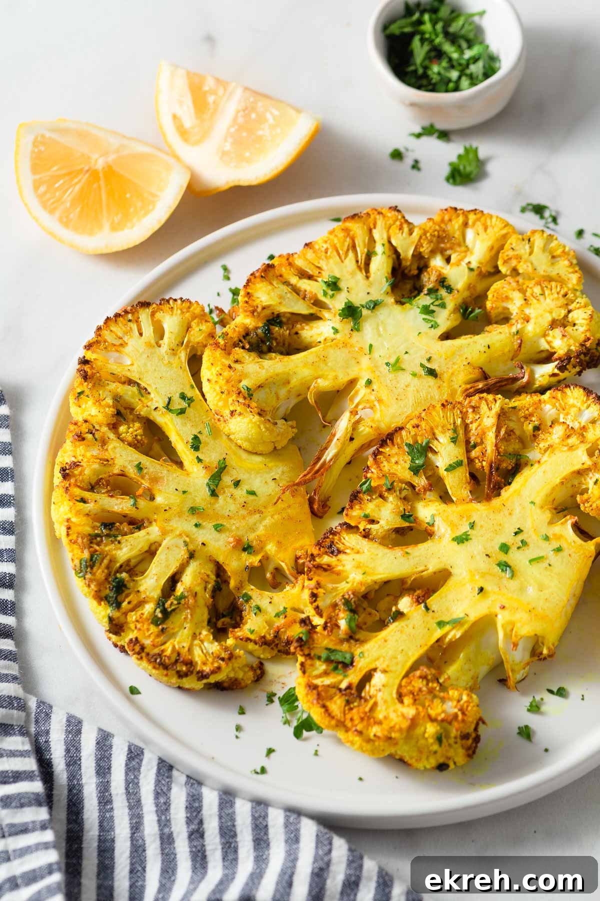 air fried cauliflower steaks on a plate.