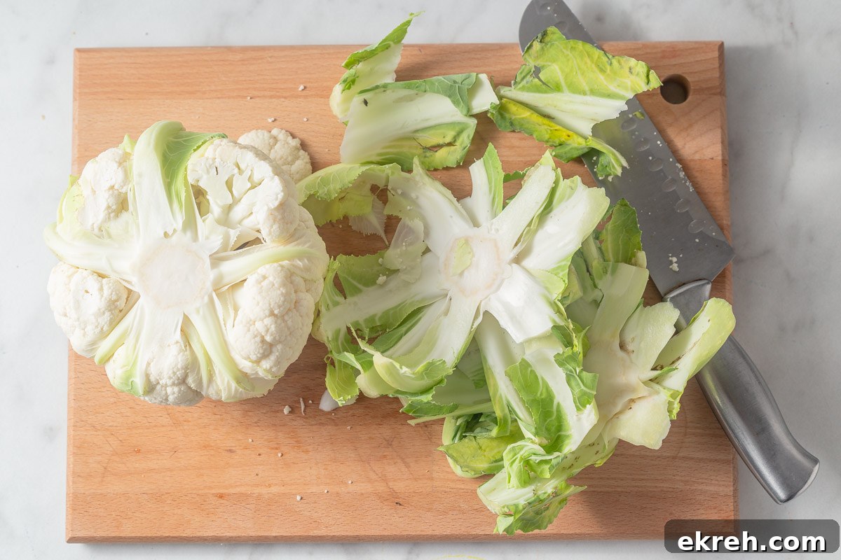 removing the outer layer of cauliflower.