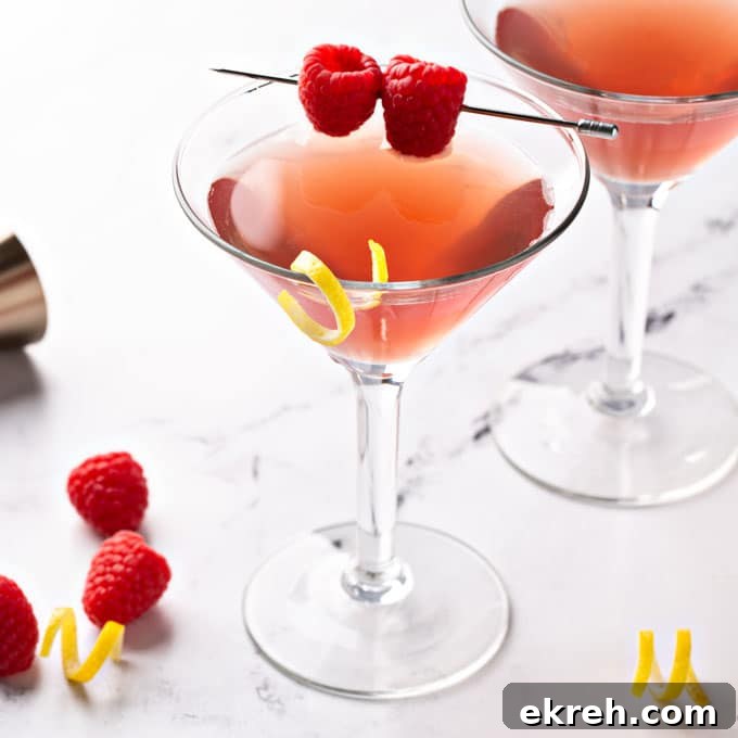 A couple of glasses with French martini garnished with braspberries