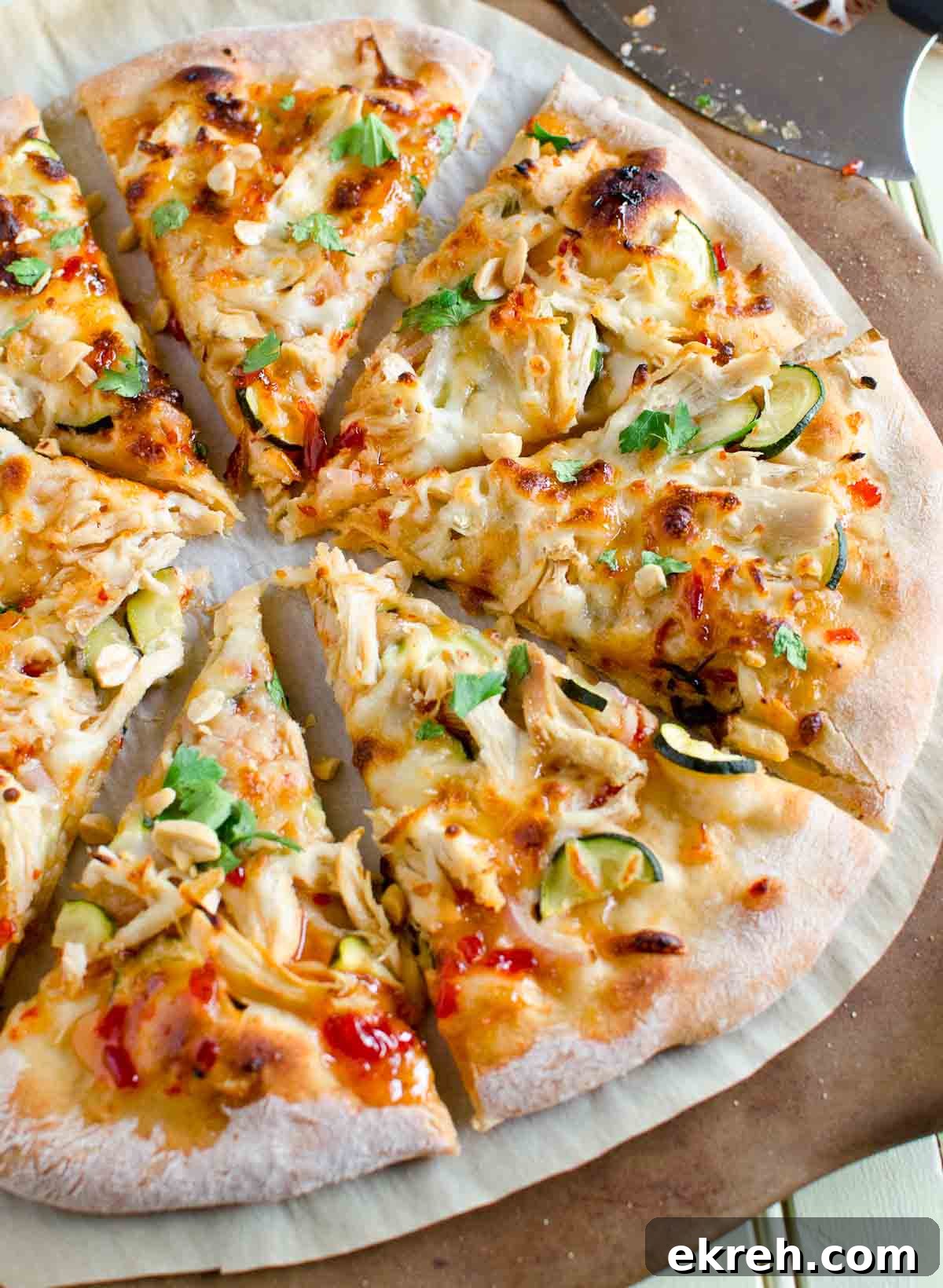 entire thai chicken pizza cut into eight slices