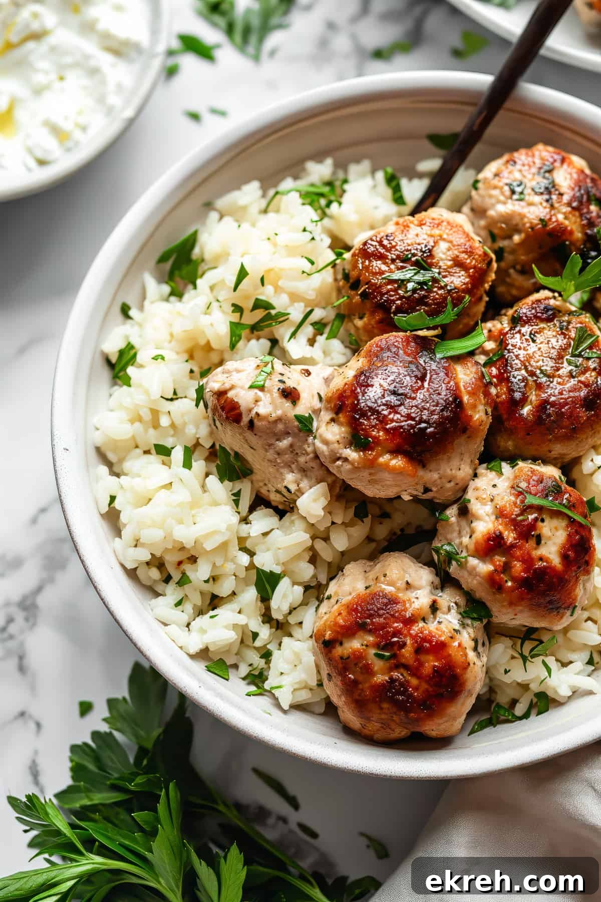 Classic Greek Chicken Meatballs with Tzatziki 2 Greek chicken meatballs with feta and rice.