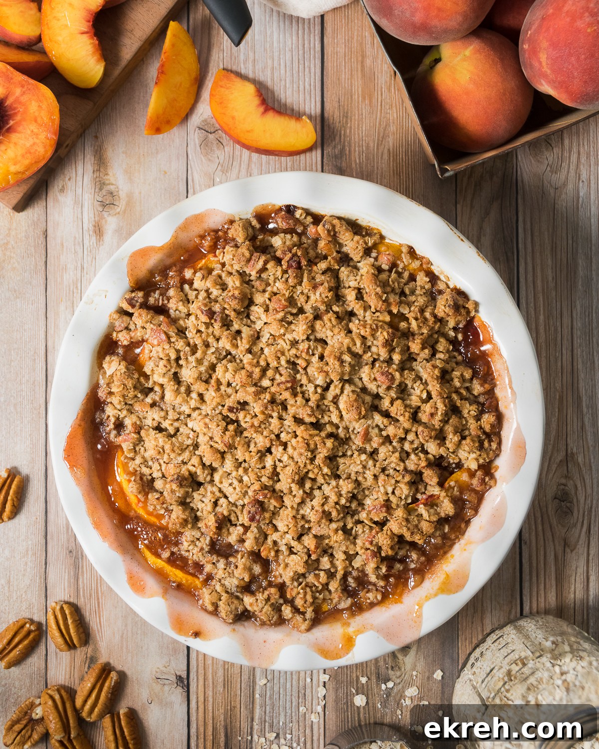 Cooked peach crisp on a wood table.