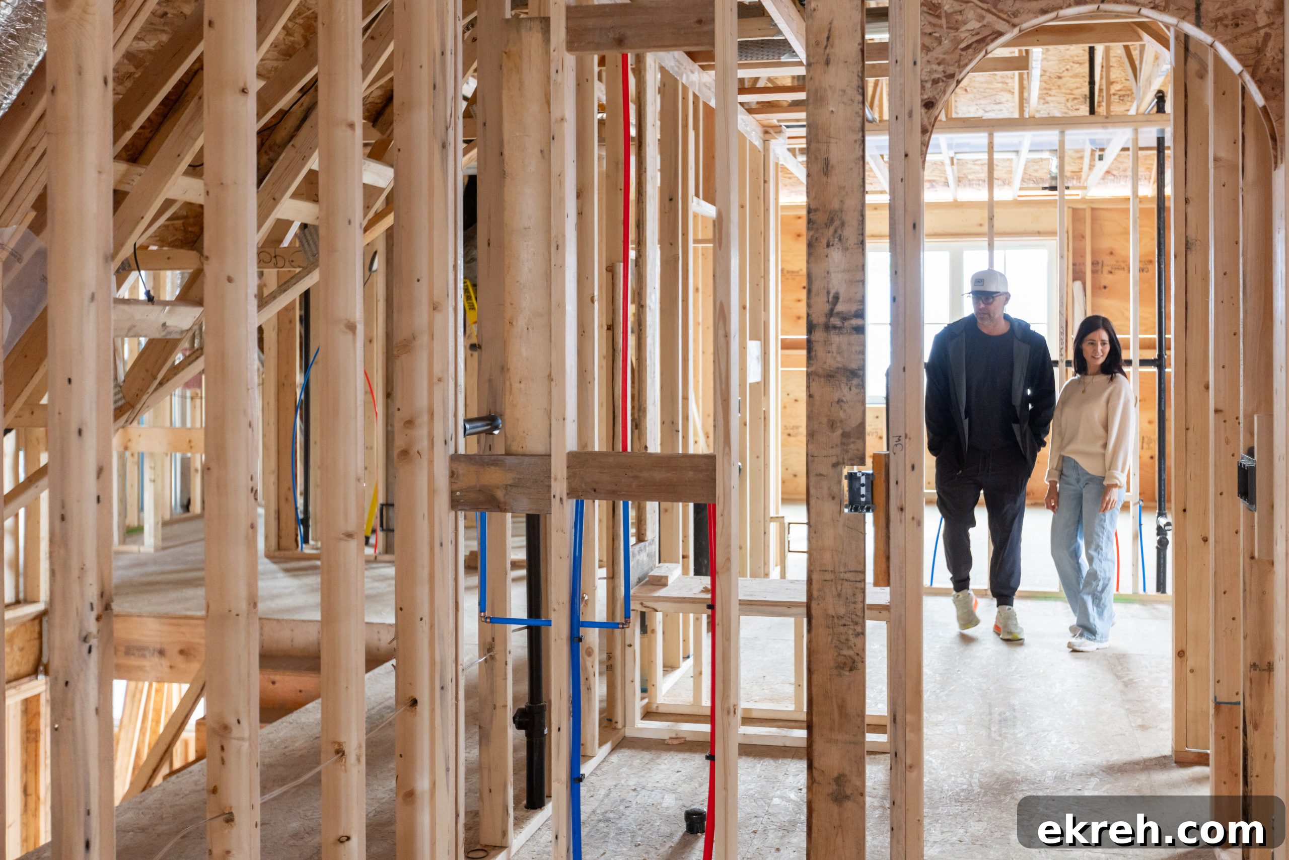 Tori and Charles, her builder and husband, walking through new build
