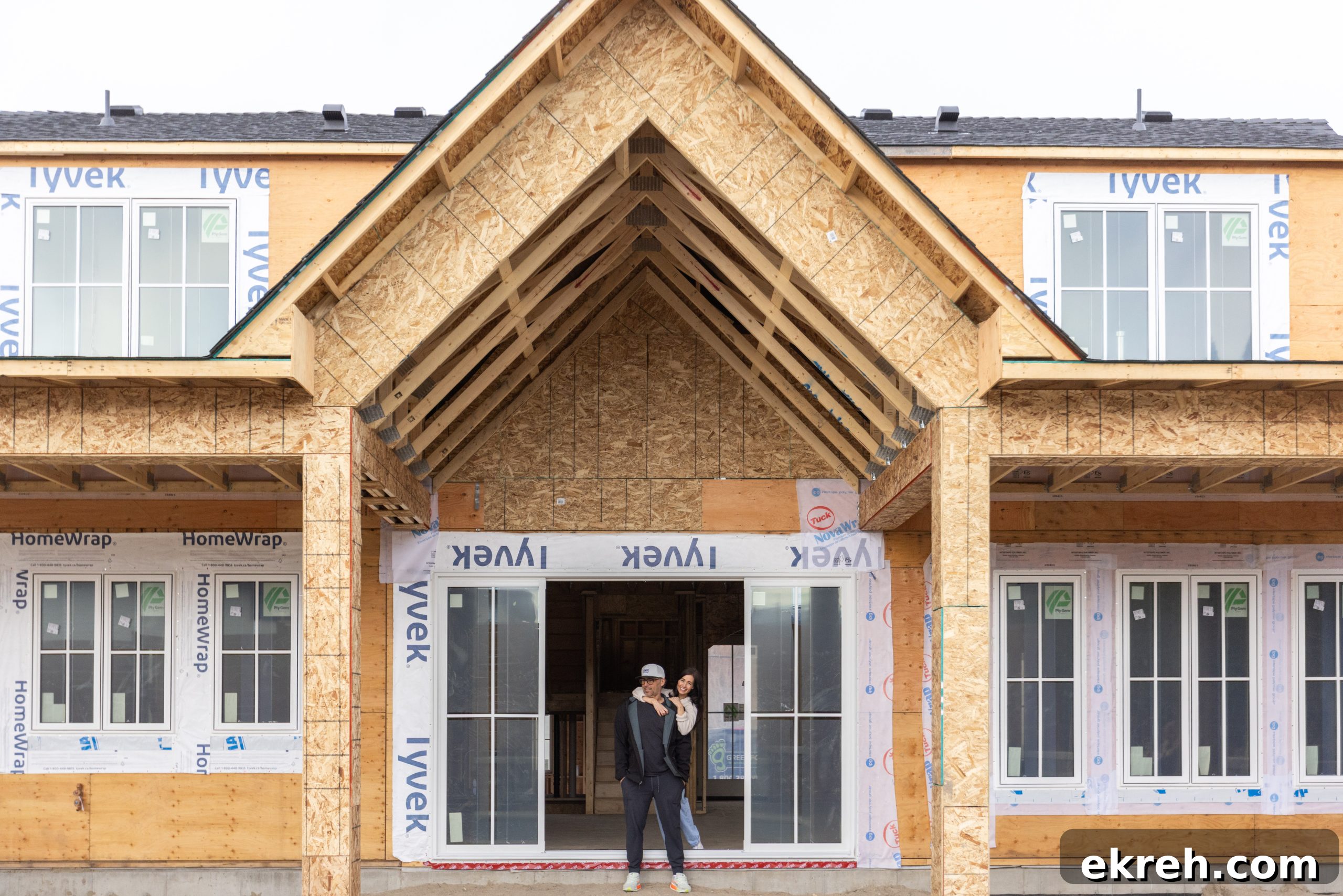 Tori and Charles - her husband and builder, outside newest build