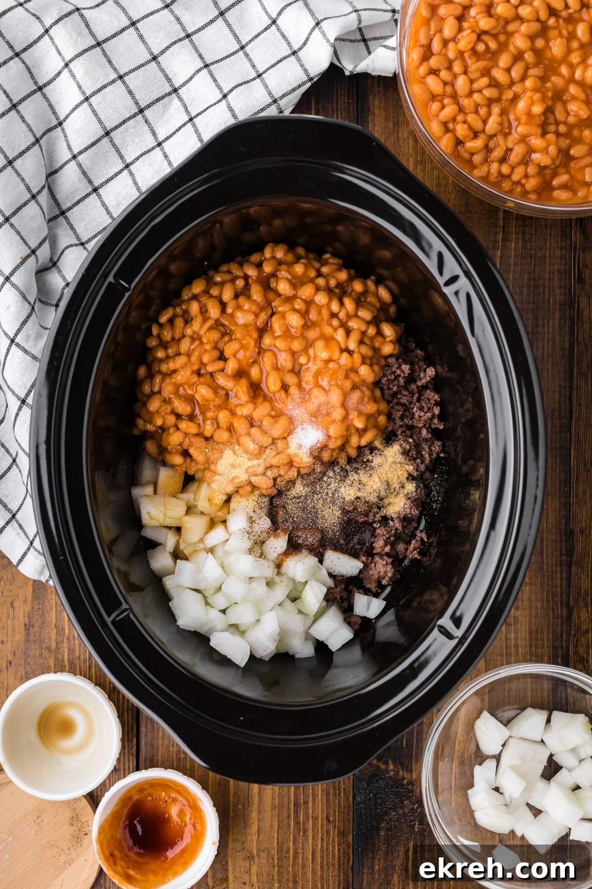 ground beef, baked beans, onions, seasonings and more in a slow cooker to make cowboy beans.