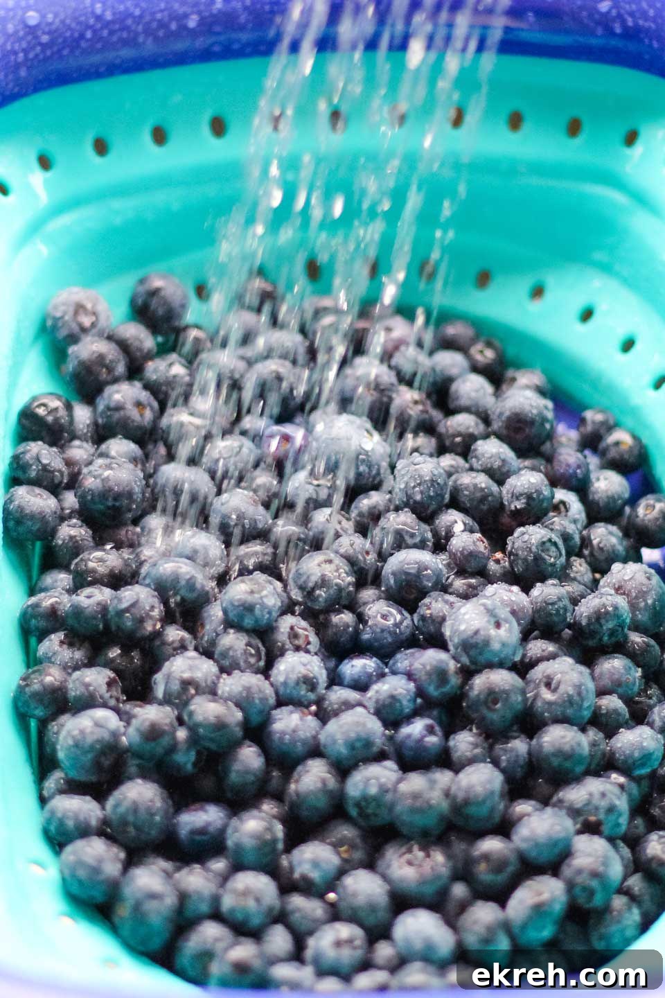 Fresh Blueberries Fresh blueberries in a strainer being rinsed.