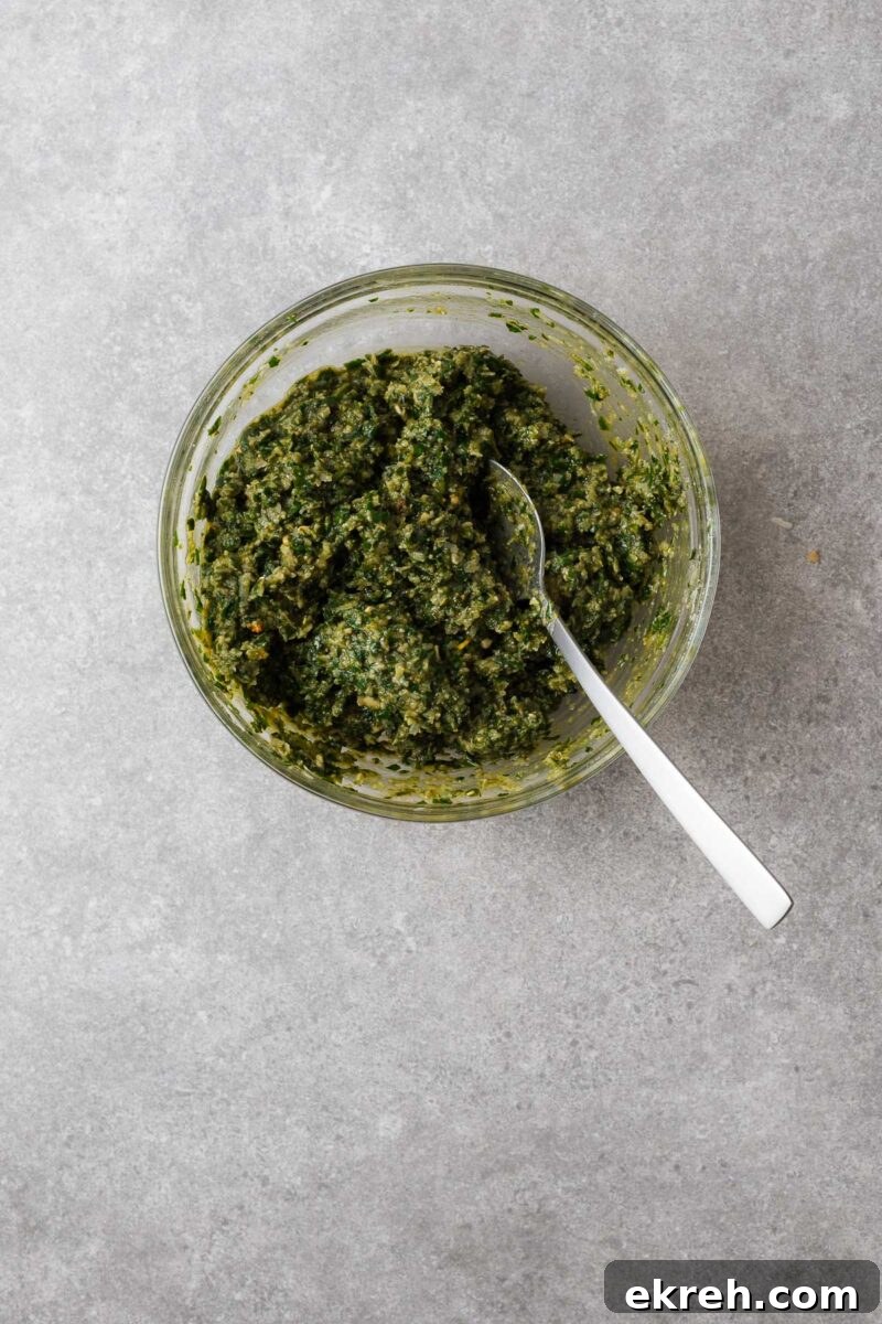 Homemade pesto in a glass mixing bowl.