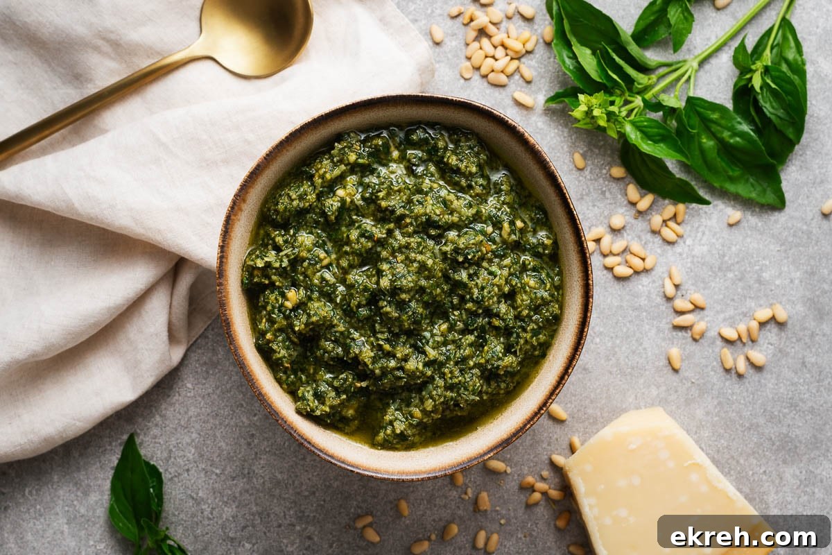 Classic basil pesto in a large bowl. The pesto is made in a food processor but has a smooth texture similar to authentic handmade Italian pesto.
